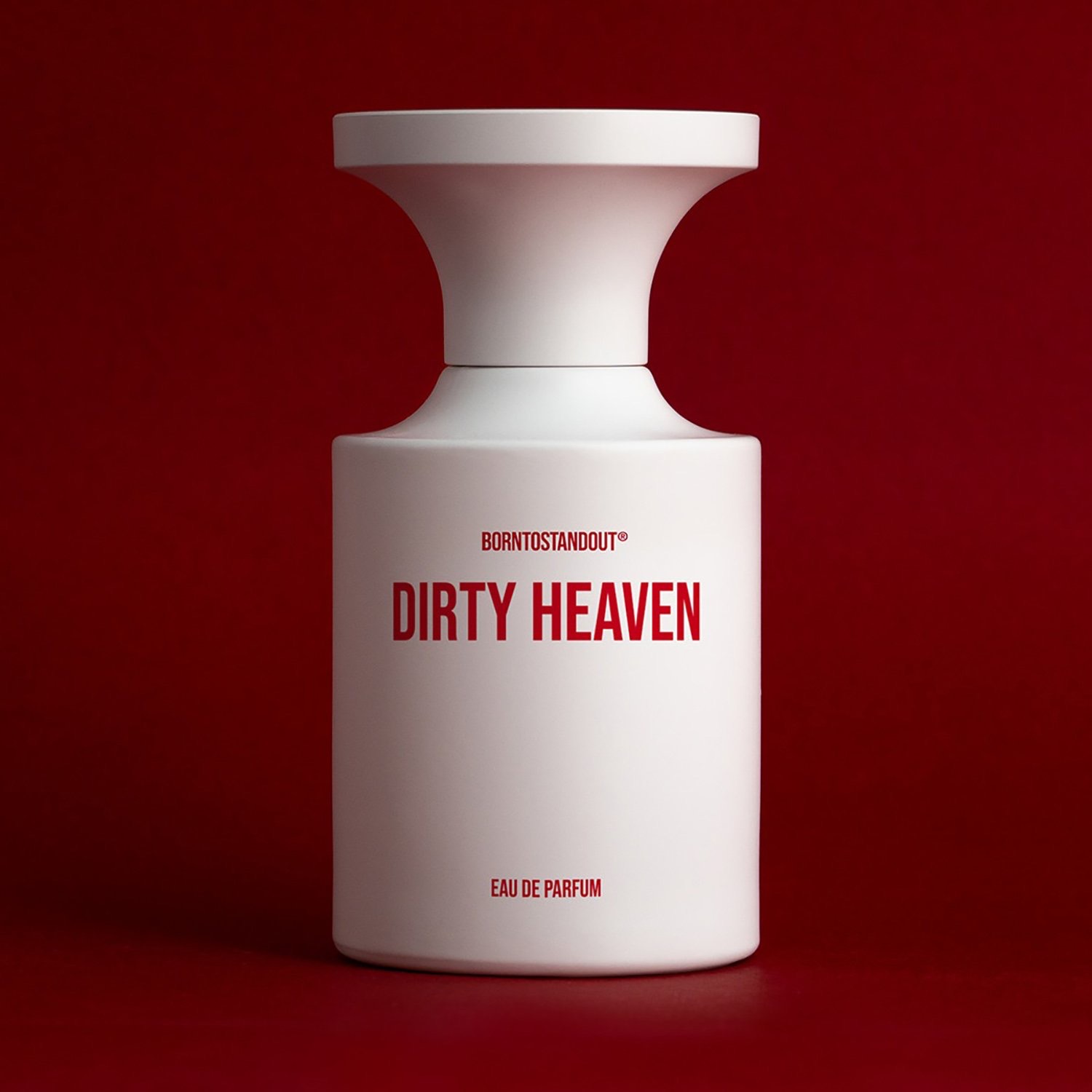 BORNTOSTANDOUT Dirty Heaven fragrance bottle on red